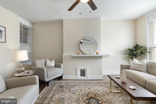 living room featuring hardwood / wood-style flooring and ceiling fan