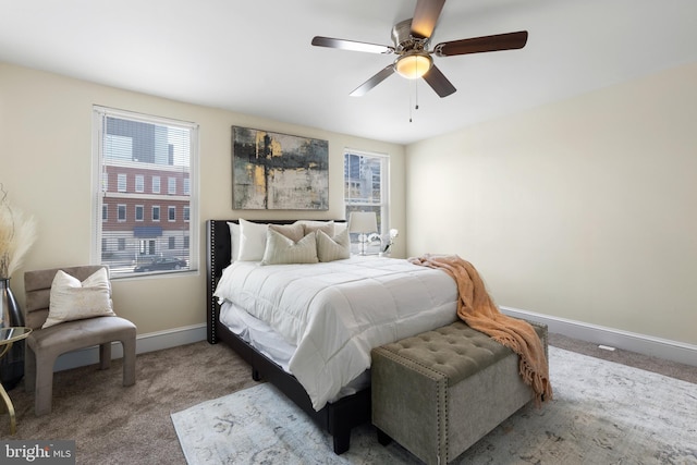 bedroom featuring carpet, ceiling fan, and multiple windows