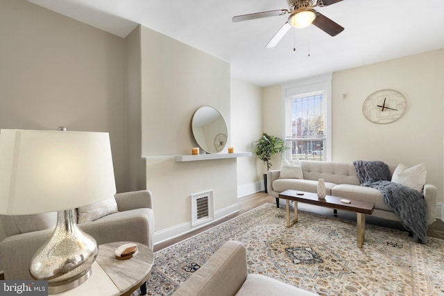 living room with hardwood / wood-style flooring and ceiling fan