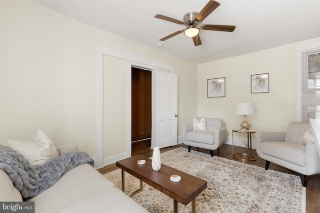 living room featuring wood-type flooring and ceiling fan