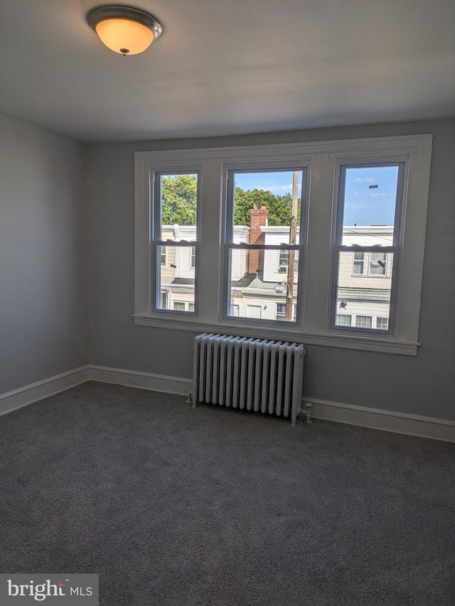 carpeted spare room with radiator