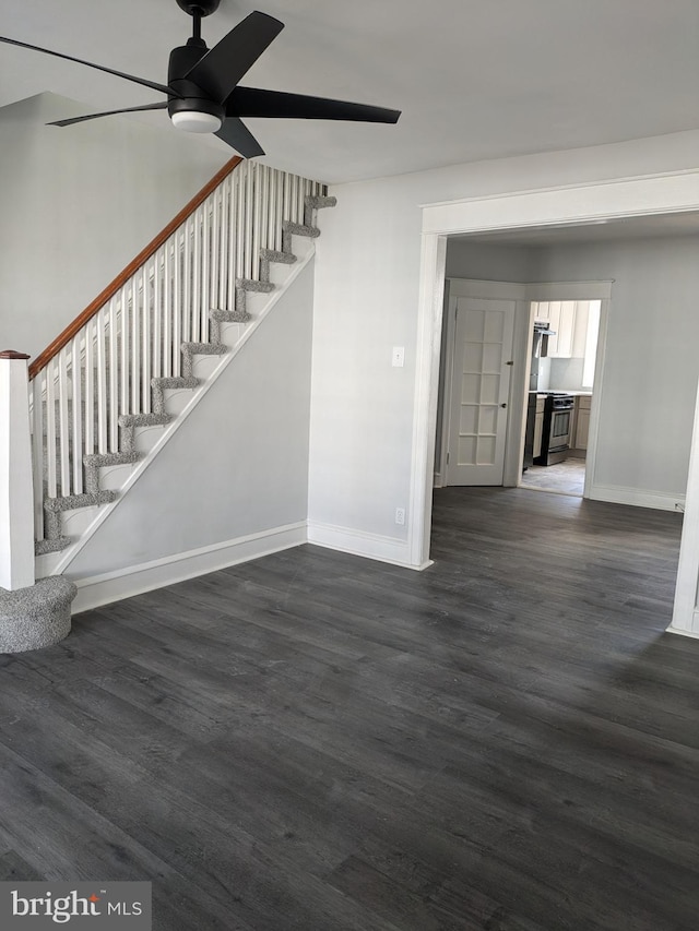 unfurnished living room featuring dark hardwood / wood-style floors and ceiling fan