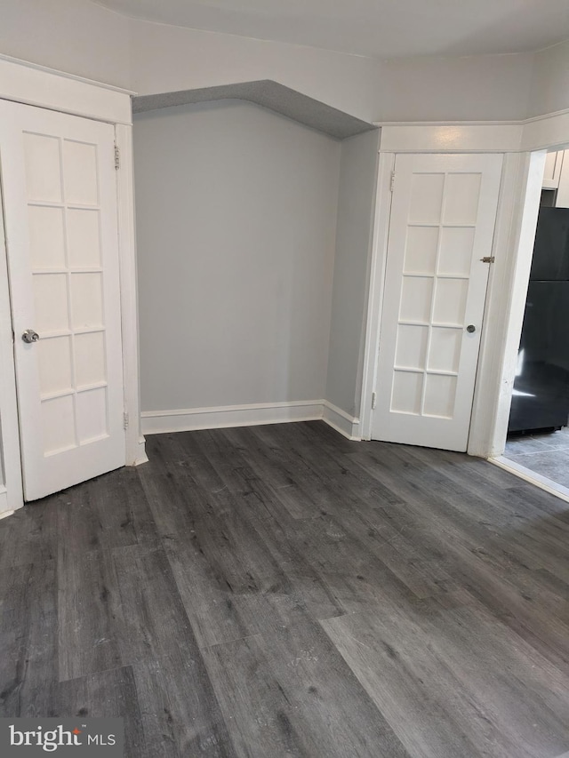 spare room featuring dark hardwood / wood-style flooring