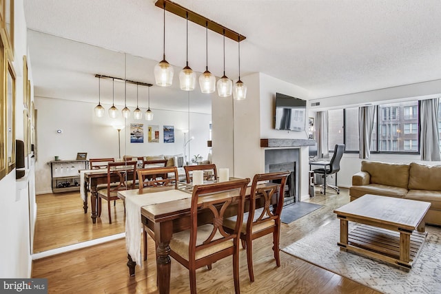 dining area featuring hardwood / wood-style floors and a textured ceiling