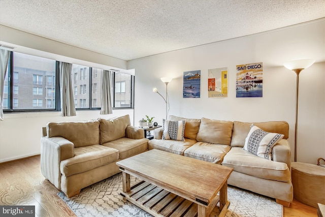 living room with a textured ceiling and light hardwood / wood-style floors