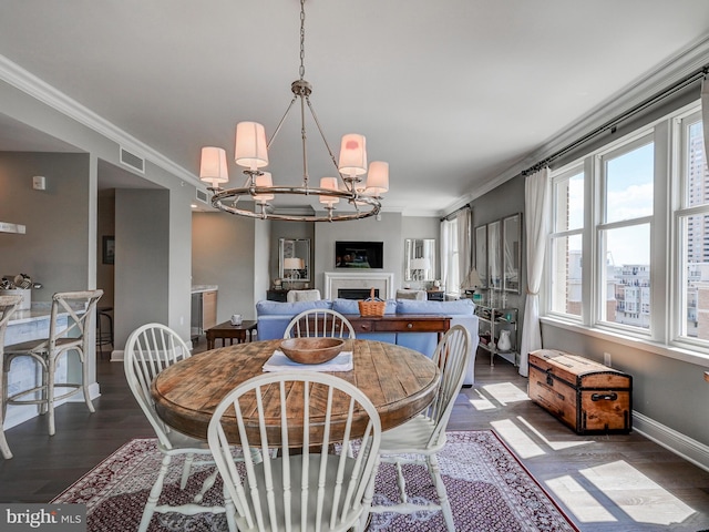 dining room featuring a notable chandelier, dark hardwood / wood-style floors, and ornamental molding