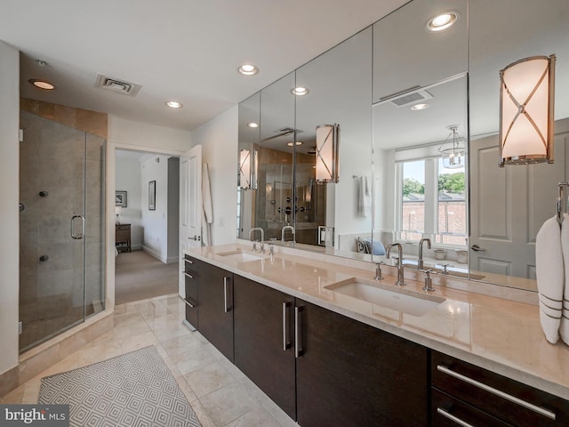 bathroom featuring vanity and a shower with door