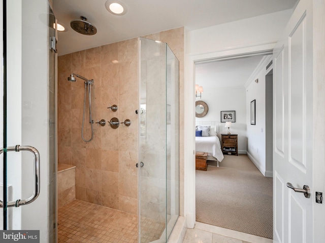 bathroom featuring a shower with shower door and crown molding