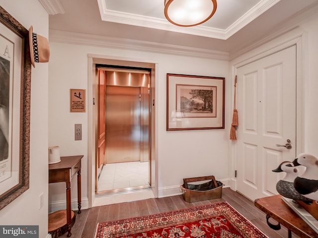 corridor with ornamental molding and elevator