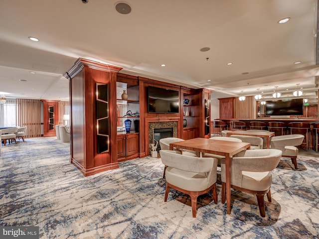 carpeted dining room featuring wood walls