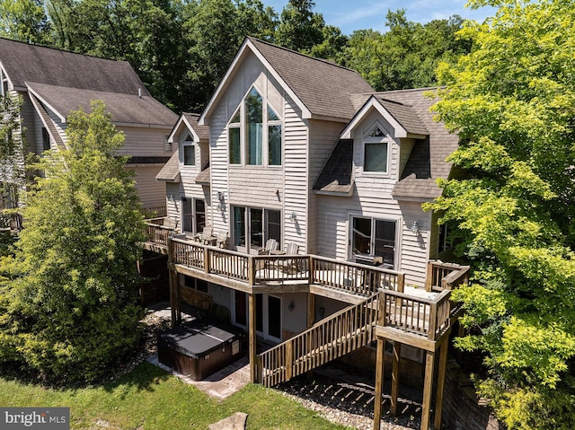 rear view of property featuring a wooden deck