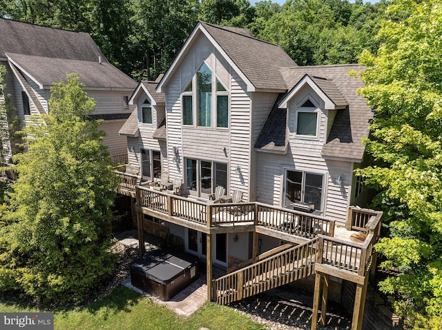 rear view of property featuring a wooden deck