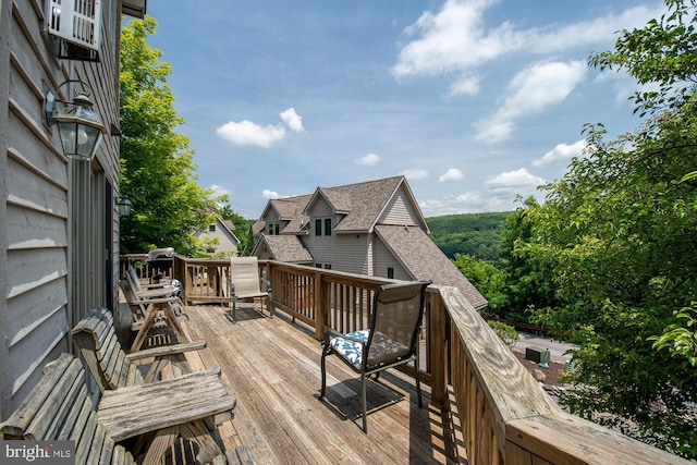 wooden terrace featuring cooling unit