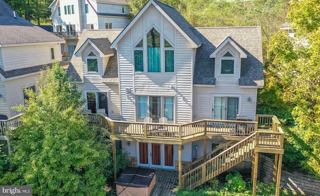 rear view of house featuring french doors and a wooden deck