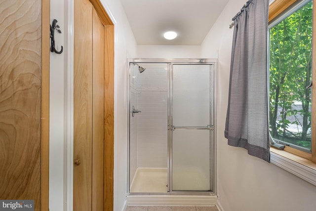 bathroom featuring tile patterned floors and an enclosed shower