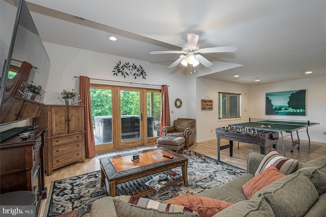 living room featuring light hardwood / wood-style floors and ceiling fan