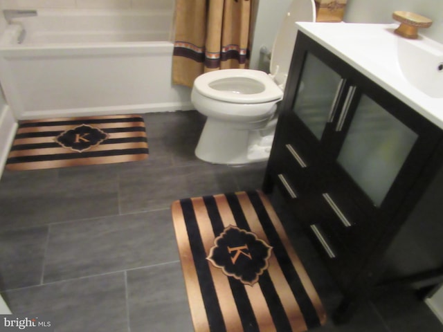 bathroom featuring vanity, tile patterned flooring, and toilet