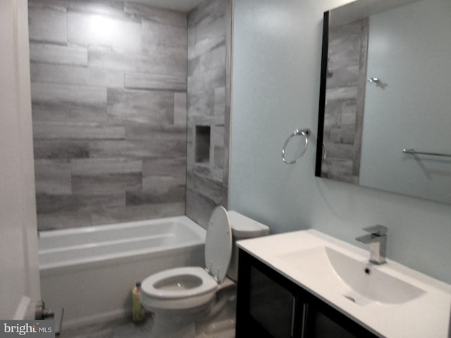 full bathroom with vanity, tiled shower / bath combo, and toilet