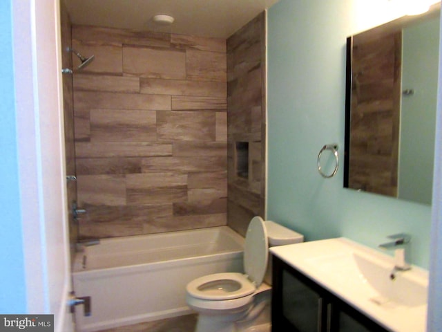 full bathroom with tiled shower / bath combo, toilet, and vanity