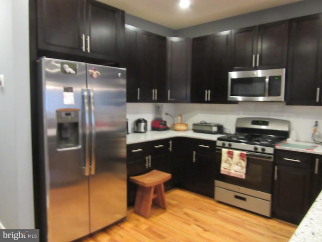 kitchen with light hardwood / wood-style flooring and stainless steel appliances