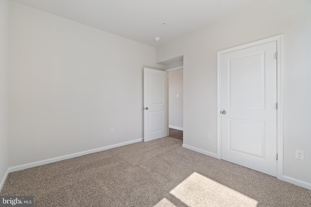 unfurnished bedroom with carpet floors