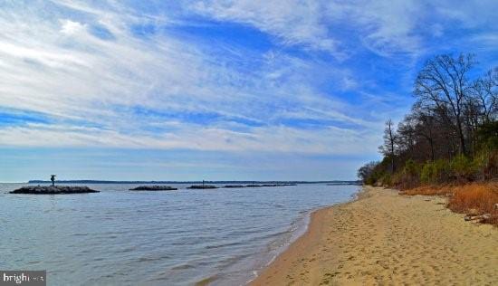 property view of water featuring a beach view