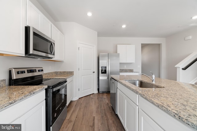 kitchen with light stone countertops, white cabinetry, sink, and appliances with stainless steel finishes