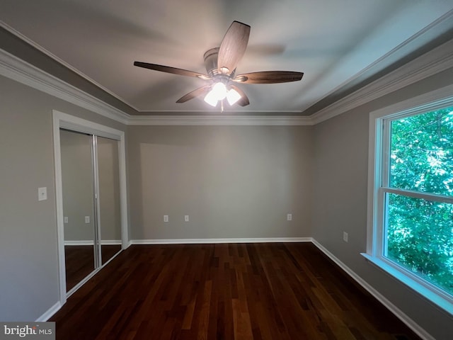 unfurnished bedroom featuring multiple windows, ceiling fan, crown molding, and dark hardwood / wood-style floors