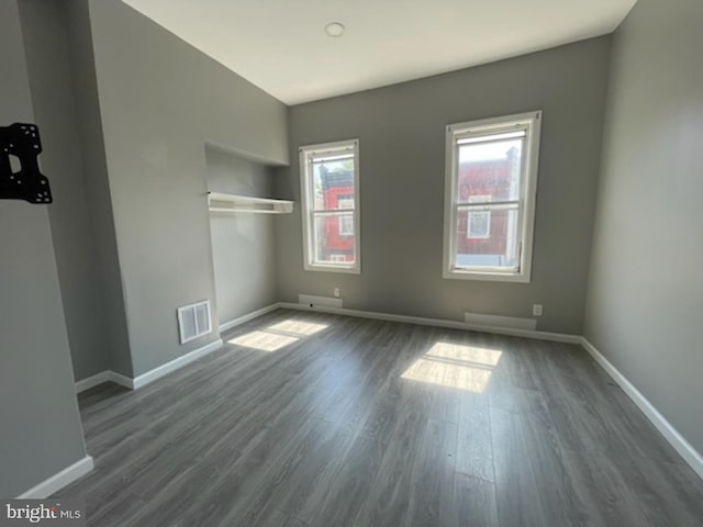 unfurnished bedroom featuring dark hardwood / wood-style flooring and a closet