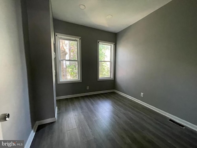 spare room featuring dark hardwood / wood-style floors