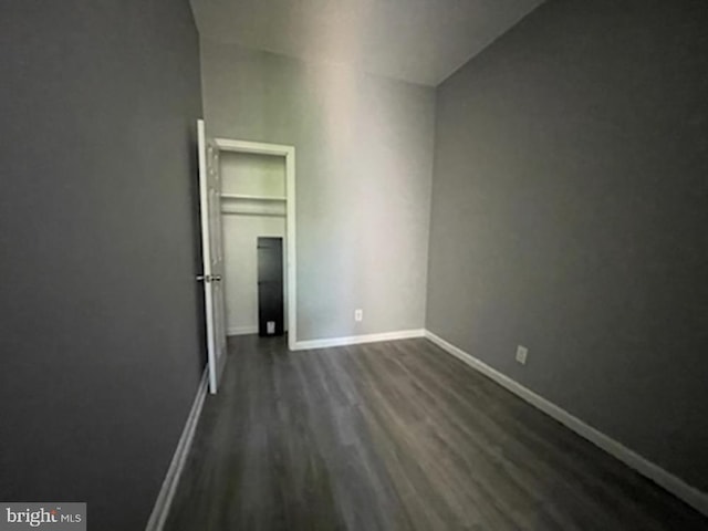 empty room with dark hardwood / wood-style floors