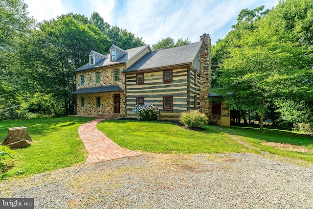 cabin featuring a front lawn