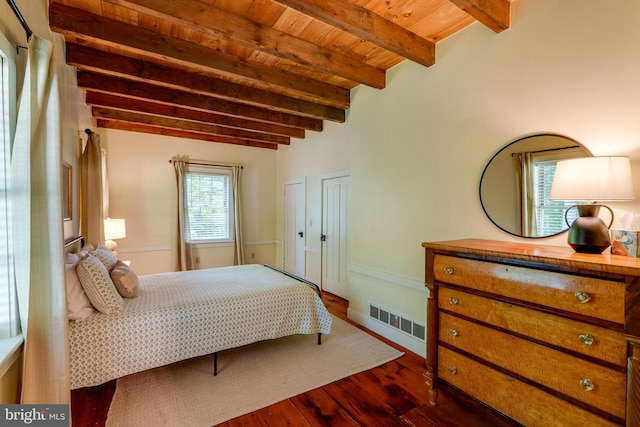 bedroom with beamed ceiling, dark hardwood / wood-style flooring, and wood ceiling