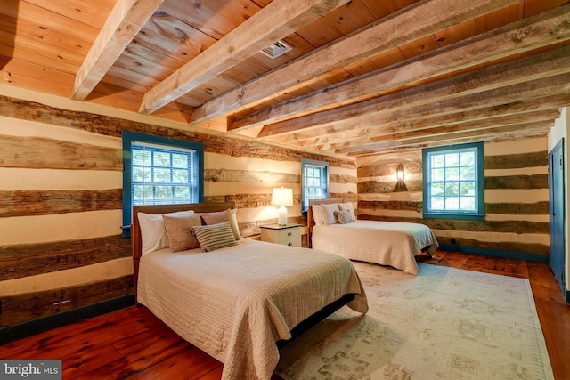 bedroom featuring beamed ceiling, wood-type flooring, and wooden ceiling