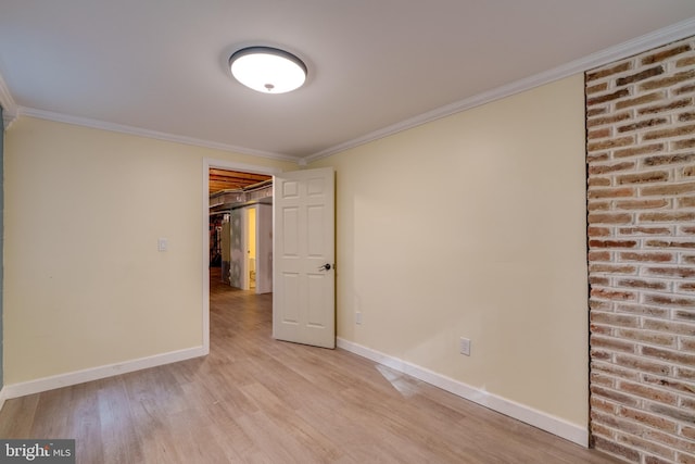 unfurnished room featuring light wood-type flooring and ornamental molding