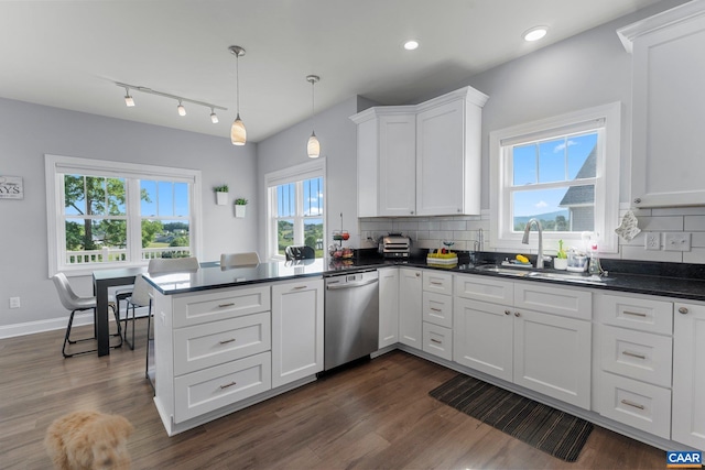 kitchen with sink, dishwasher, hanging light fixtures, white cabinets, and kitchen peninsula