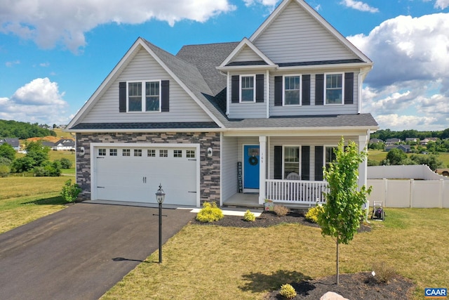 craftsman inspired home with a porch, a garage, and a front lawn