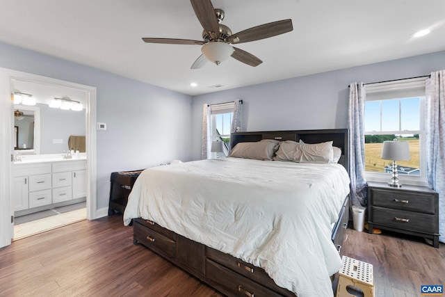 bedroom with ensuite bath, ceiling fan, and dark wood-type flooring