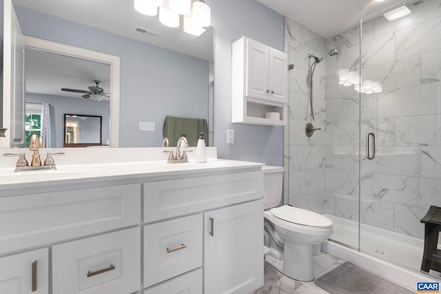 bathroom featuring vanity, ceiling fan, a shower with shower door, and toilet