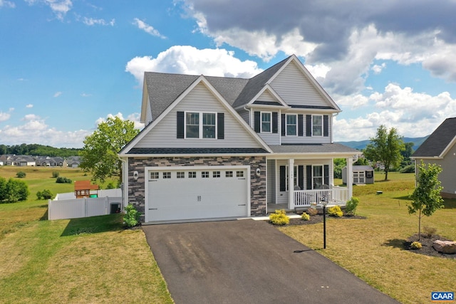 craftsman-style home featuring a front yard, a porch, and a garage