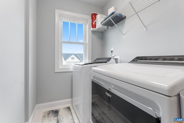 laundry room with separate washer and dryer and wood-type flooring