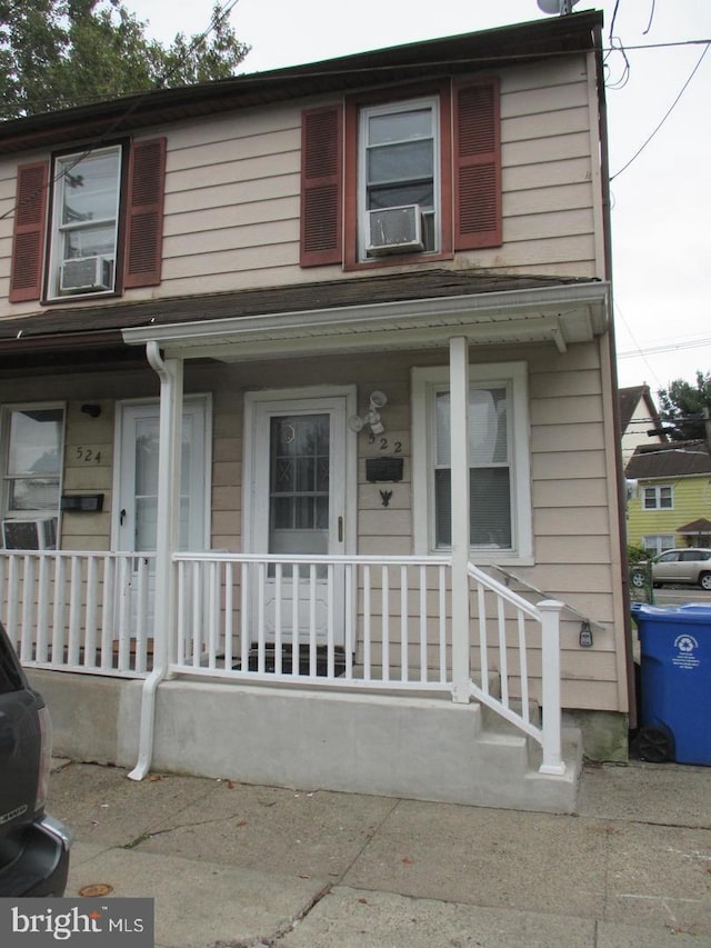 view of front facade featuring cooling unit and covered porch