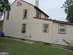 view of property exterior with a yard