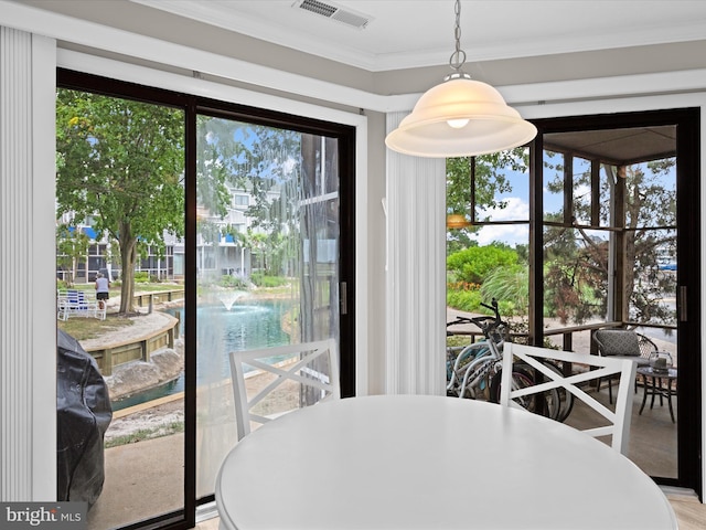 dining space with crown molding