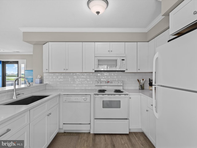 kitchen with white appliances, crown molding, sink, dark hardwood / wood-style floors, and white cabinetry