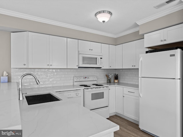 kitchen with sink, tasteful backsplash, crown molding, white appliances, and white cabinets