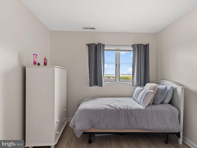 bedroom with hardwood / wood-style flooring