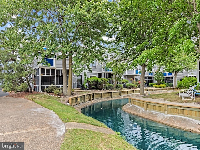 view of swimming pool featuring a sunroom