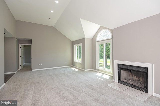 unfurnished living room featuring light colored carpet and vaulted ceiling