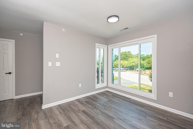 unfurnished room featuring dark hardwood / wood-style flooring